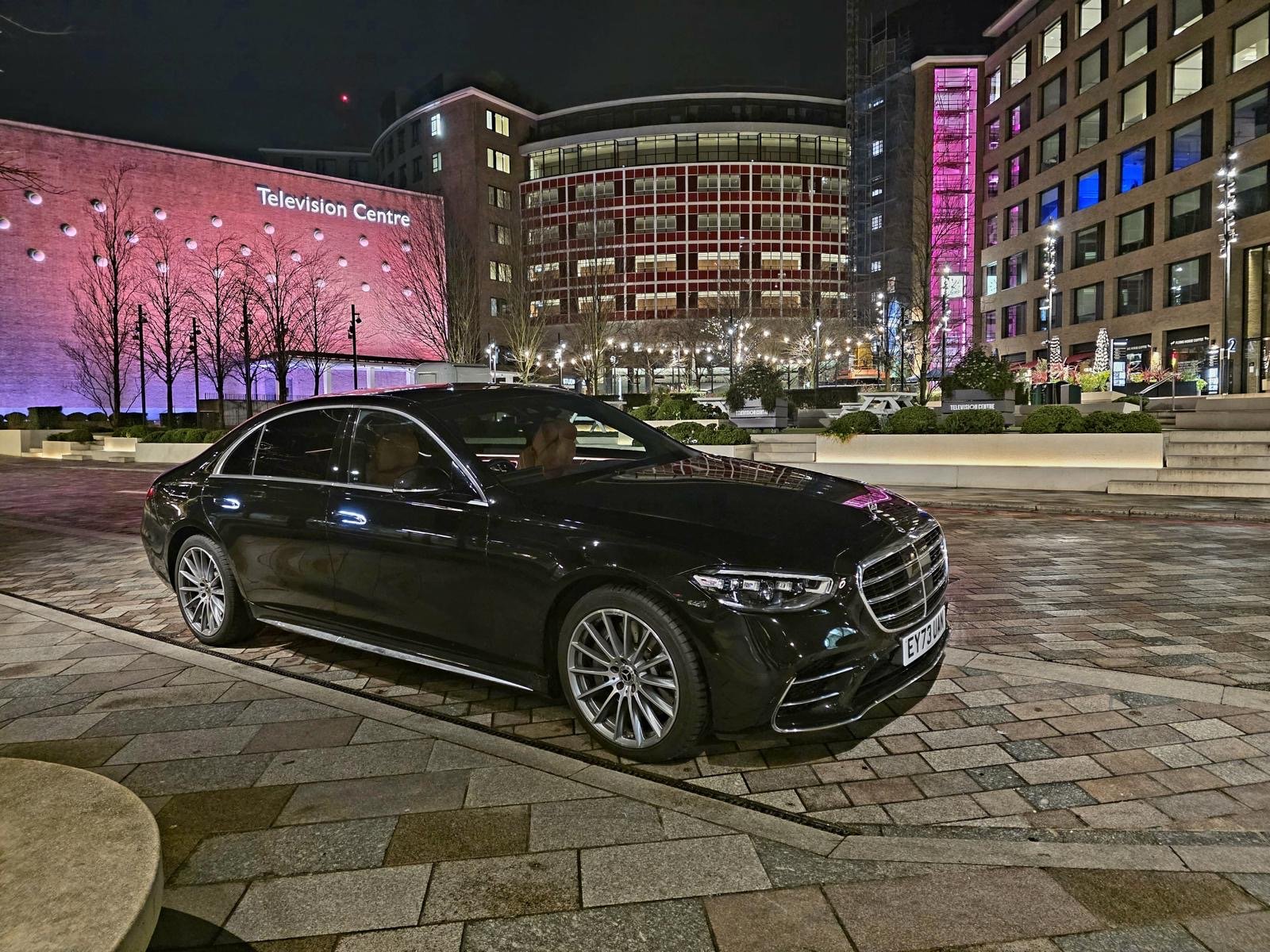 Chauffeur car outside a London hotel at night