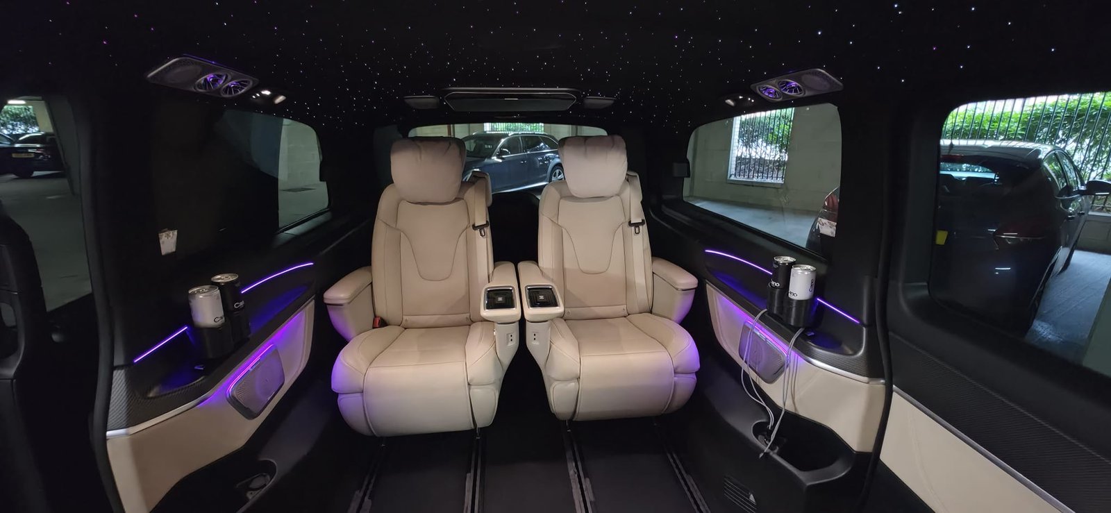 Luxury Mercedes V-Class cabin with captain's chairs and ambient lighting
