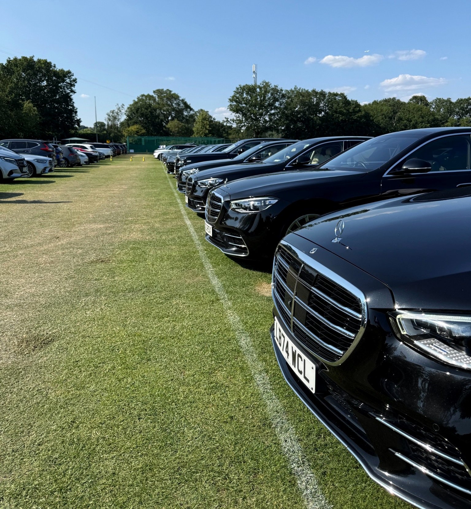 Chauffeur cars lined up at a sporting event