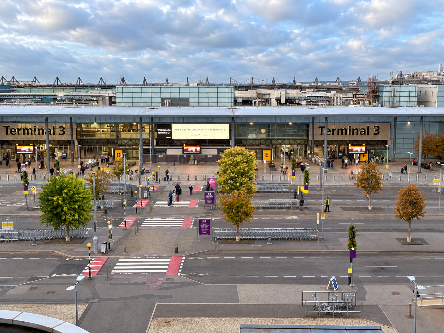 Black Royale chauffeur meeting a passenger for a Heathrow airport transfer